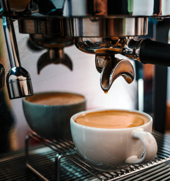 istock Coffee extraction from the coffee machine with a portafilter pouring coffee into a cup,Espresso pouring from the coffee machine at coffee shop 1665407014