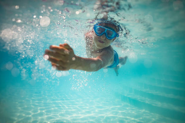istock Little boy swimming underwater in pool 1665408673