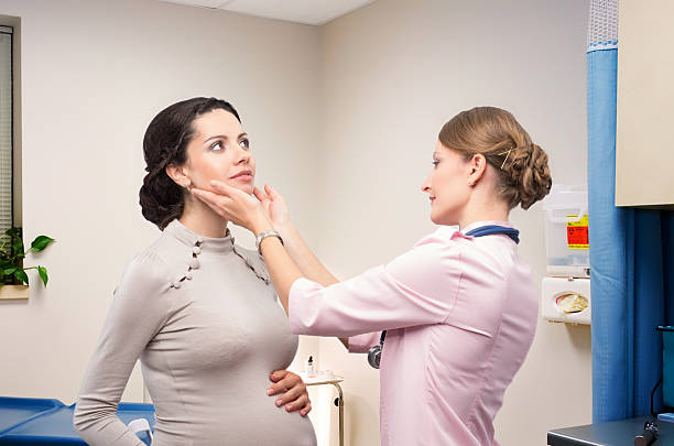 Doctor endocrinologist checking thyroid pregnant Doctor endocrinologist checking thyroid young pregnant women thyroid gland stock pictures, royalty-free photos & images