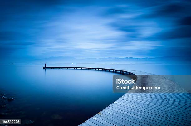 Curve Of The Jetty And Man Stock Photo - Download Image Now - Blue, Landscape - Scenery, Nature