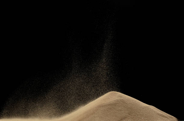 istock Wind blow on sand hill and splash fly in air. Sand dune hill over wind storm and blast dust splash over mountain. Sunshine afternoon on sand hill wind blow. Black background isolated 1665446233