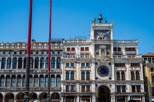 Venice, Italy – June 16, 2023: St. Mark's clock tower in Venice is an early Renaissance building on the north side of the Piazza San Marco, which date back to 15th century.