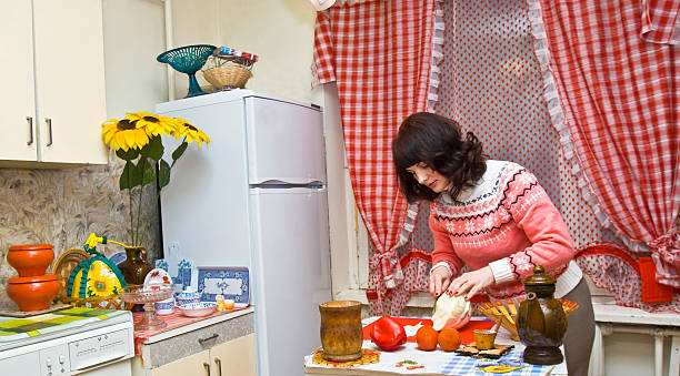 istock Woman in kitchen cooking 166545857