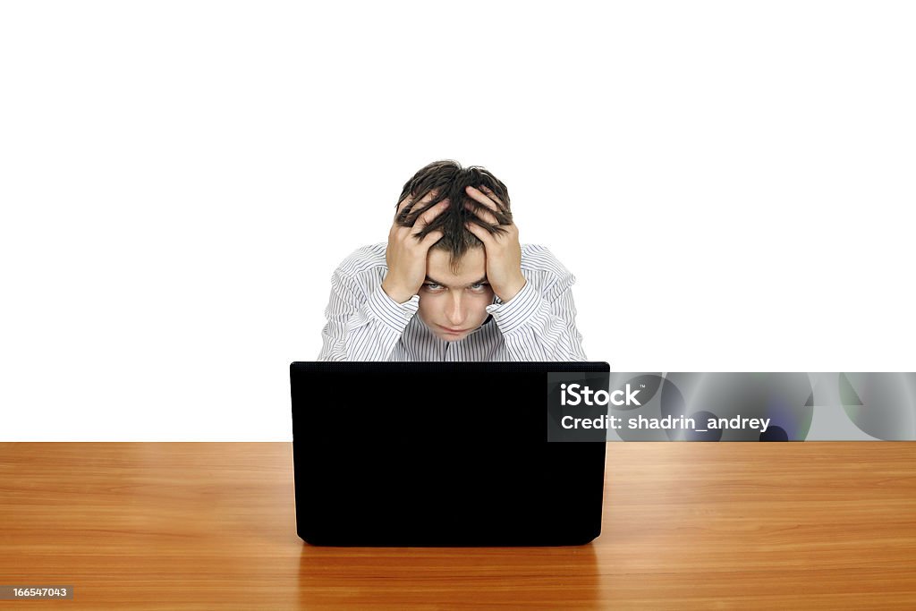 Young Man With Laptop Sad and Troubled Teenager with Laptop. Isolated on the White Background Computer Stock Photo