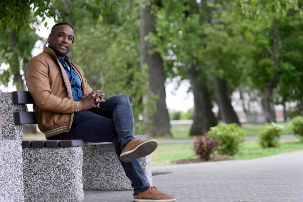 istock dark-skinned man breathes fresh air strolling through the park 1665472877