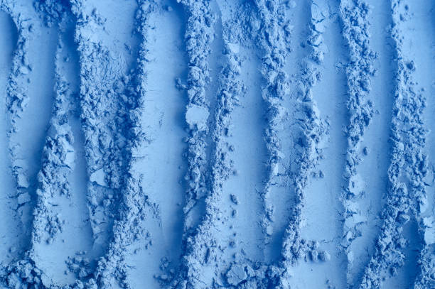 istock Light blue bentonite facial clay powder (alginate modeling mask, eye shadow, body wrap) texture close up, selective focus. Abstract background with brush strokes. 1665478252