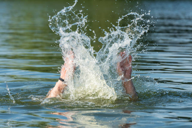 istock Hands of a drowning man above water in need of help 1665480433