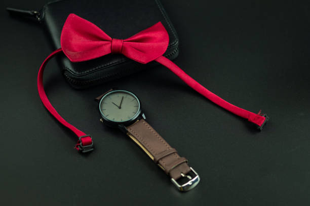 istock Black men wallet, red bow tie and leather wristwatch 1665499070