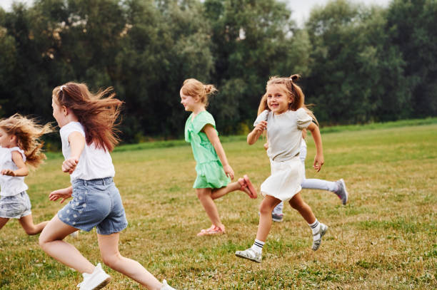 istock Running, active time spending. Kids are having fun on the field at daytime together 1665499629