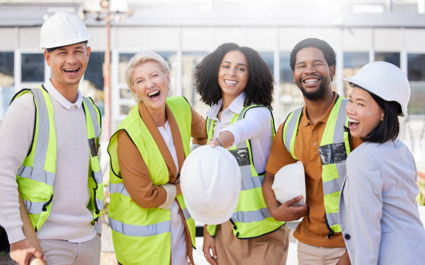 istock Team, architecture and helmet, diversity and construction with maintenance, contractor and happiness. Engineering, working together and property development, urban infrastructure and collaboration 1665503603
