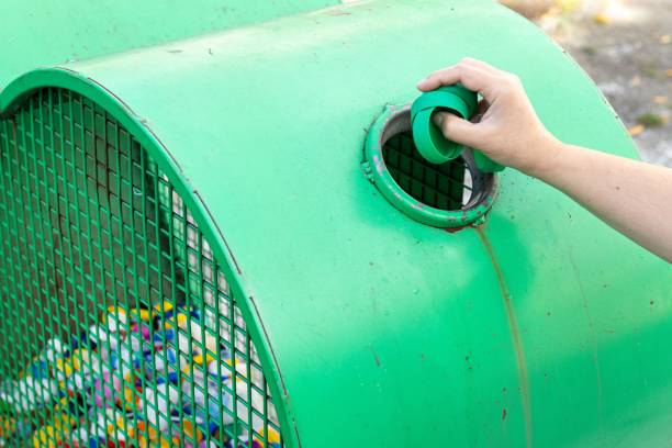 istock Woman hand throwing a plastic caps into a recycling bin 1665505861