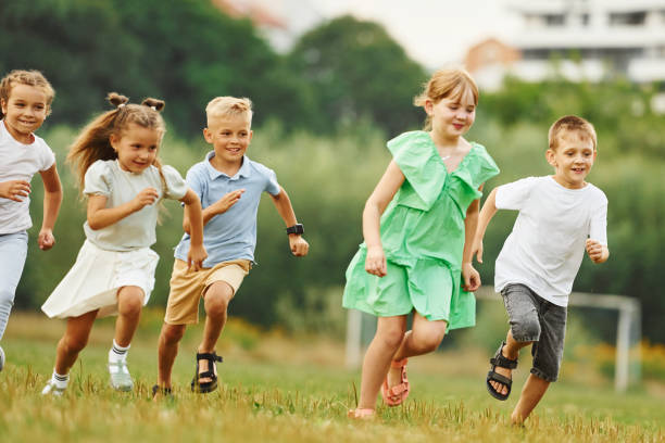 istock Running, active time spending. Kids are having fun on the field at daytime together 1665510337