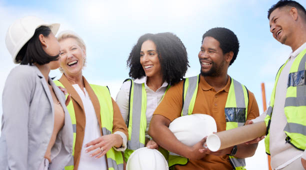 istock Architecture team, happy people and construction, engineering or planning project of outdoor development. Building contractor, industrial designer and funny discussion in group diversity and planning 1665510364