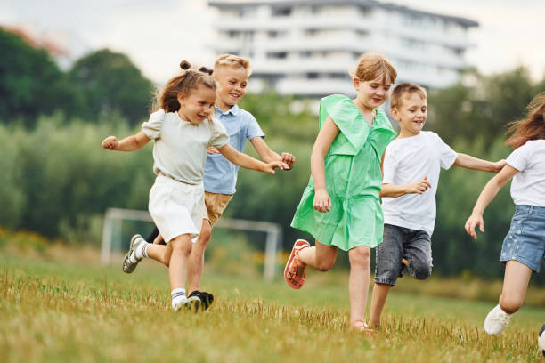 istock Running, active time spending. Kids are having fun on the field at daytime together 1665511486
