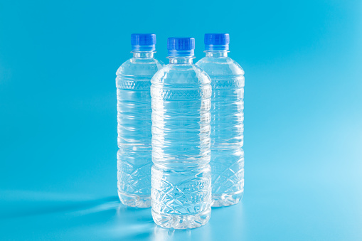 Bottled water on blue background.