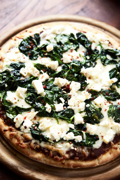 istock Pizza with mozzarella cheese and spinach. Dark wooden background. Close up. 1665524261