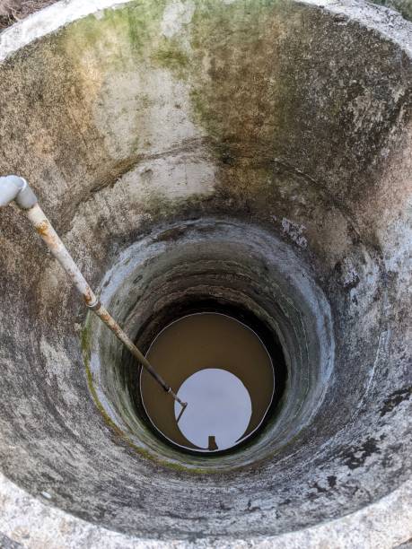 istock an old neglected round well with moss stains on the walls 1665541686
