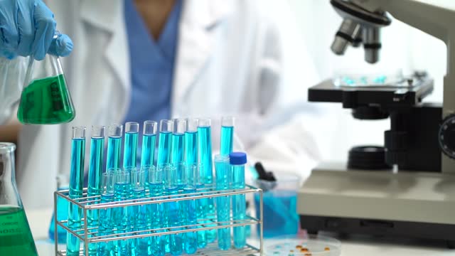 Female biotechnologist testing new chemical substances in a laboratory.