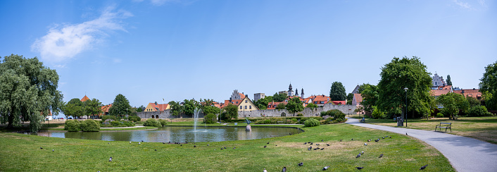 Set against the broader cityscape of Visby, Almedalen Park provides a lush, green contrast to the historic architecture and medieval structures that characterize the town. This public space serves as both a recreational area and a communal gathering point, enriching the urban experience in this UNESCO World Heritage-listed island city.