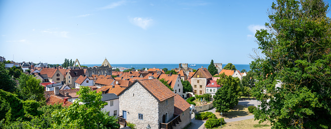 On a beautiful summer day, the Visby cityscape presents a picture-perfect scene, complete with the shimmering seascape as a backdrop. Historic architecture, medieval structures, and cobblestone streets come alive under the sun, while the Baltic Sea lends an air of tranquil beauty to this UNESCO World Heritage-listed island city.