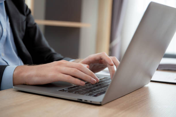 istock Hands young caucasian businessman using laptop computer planning for success in modern office, businessman typing on notebook doing marketing, executive or manager with handsome, business concept. 1665576047