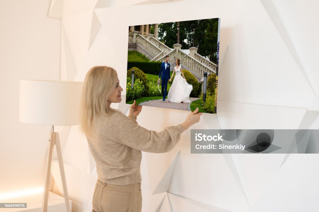 Canvas with printed photo on white wall in living room Canvas with printed photo on white wall in living room. Artist's Canvas Stock Photo
