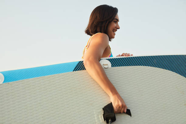 istock Paddle-board entering the water with the board in hand. 1665614313