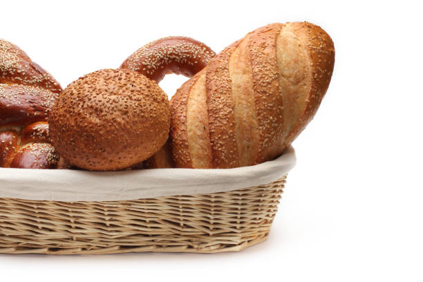 istock Baked bread in wicker basket on white background. 1665618617