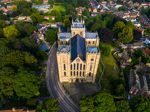 Drone shot of Ripon cathedral from above. The sun is shining on the Cathedral during golden hour.