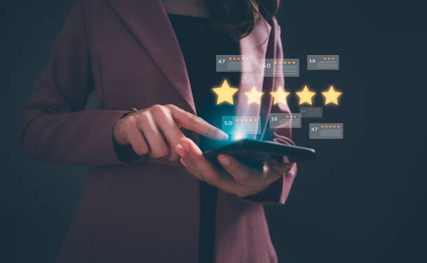 istock Close up woman hand using digital tablet or smartphone with popup five stars icon for feedback review satisfaction service. Customer service experience and business satisfaction survey. 1665634786