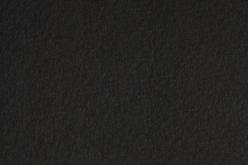 Black paper canvas grain texture empty copy space background.