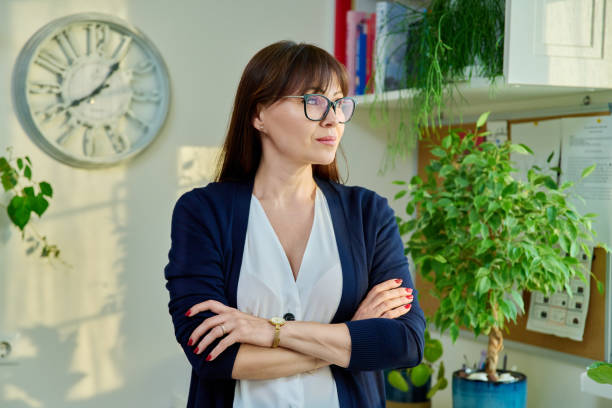 istock Middle aged elegant confident woman looking at window 1665653410