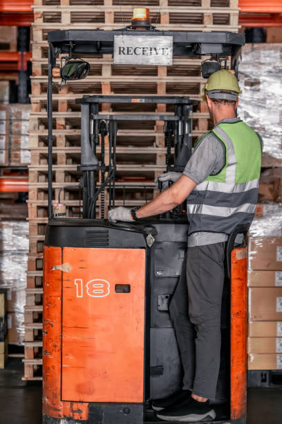 istock Warehouse forklift operator moves, stores merchandise, stays in touch with team, boss via radio 1665658593