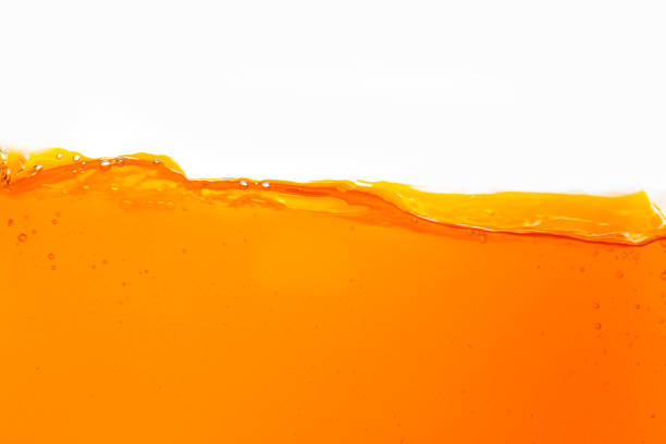 istock Macro orange juice texture isolated white background,Close-up Orange juice with bubbles on a white background. 1665662481