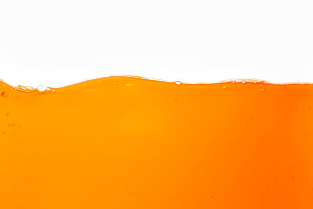 istock Macro orange juice texture isolated white background,Close-up Orange juice with bubbles on a white background. 1665662487