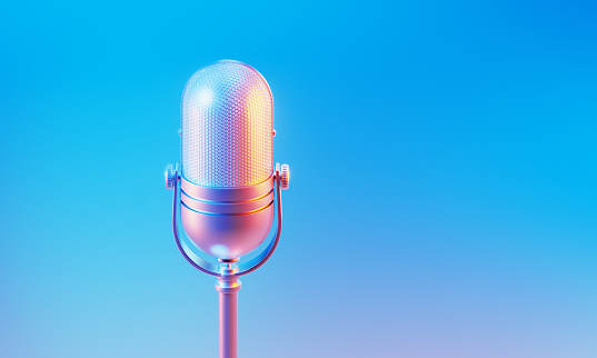 Microphone illuminated by blue and pink lights on blue and pink background. Horizontal composition with copy space.