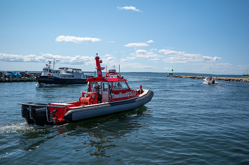 New York, USA - Jul 24, 2019: The Coast Guard patrolling the New York harbor off Lower Manhattan and escorting the Staten Island Ferry late in the day.