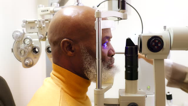 Black man, senior patient and eye exam, scan retina for vision with expert at optometry clinic, help and trust with machine. Assessment, eyecare and health with laser, results and lens prescription
