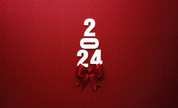 赤い背景に赤い蝶ネクタイを持つクリスマスツリーを形成する2024年のテキスト