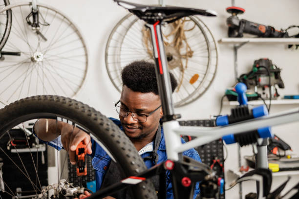 istock Bicycle mechanic works on customer bicycle in workshop 1665691248