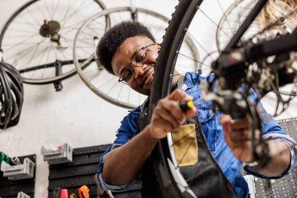 istock Bicycle workshop owner adjusts rear derailleur on bicycle 1665693620