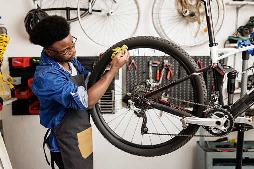 Bicycle mechanic cleaning mountain bike after repairs