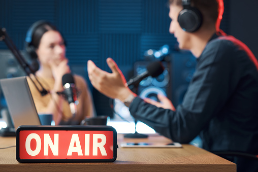 Interview broadcasting at the radio station, On Air sign in the foreground, entertainment and media concept