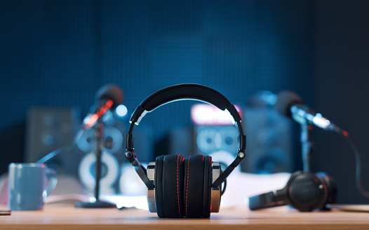 Radio broadcasting station professional equipment: headphones in the foreground