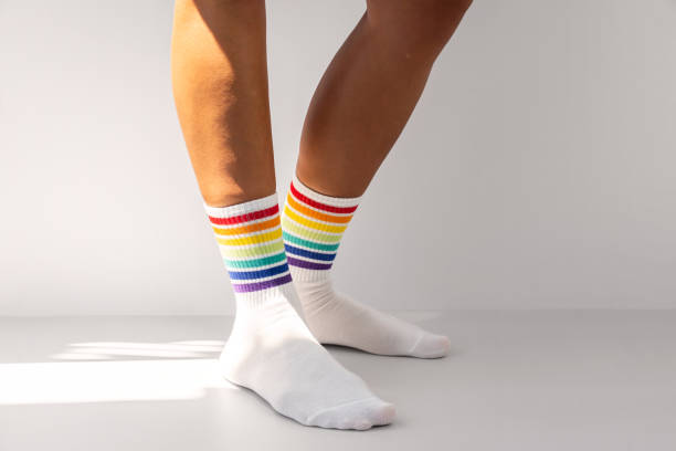 istock Human legs wearing rainbow socks as LGBT flag. 1665699202