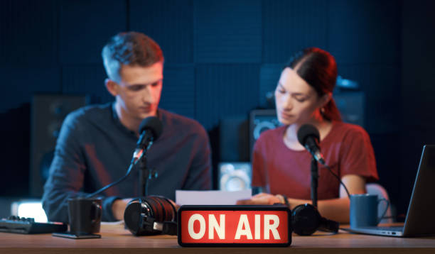 istock Young radio hosts working in the studio 1665699772