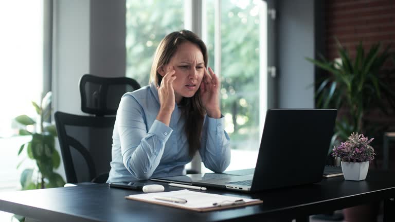 Portrait Of Businesswoman Having Ache After Work Overload