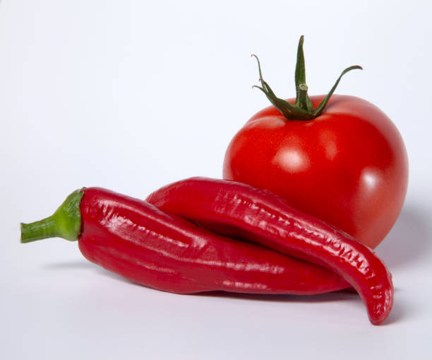 istock Two hot peppers and a tomato 1665715030