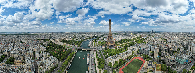 Panoramic aerial view of the city of Paris, France, showing the Seine and the Eiffel Tower.