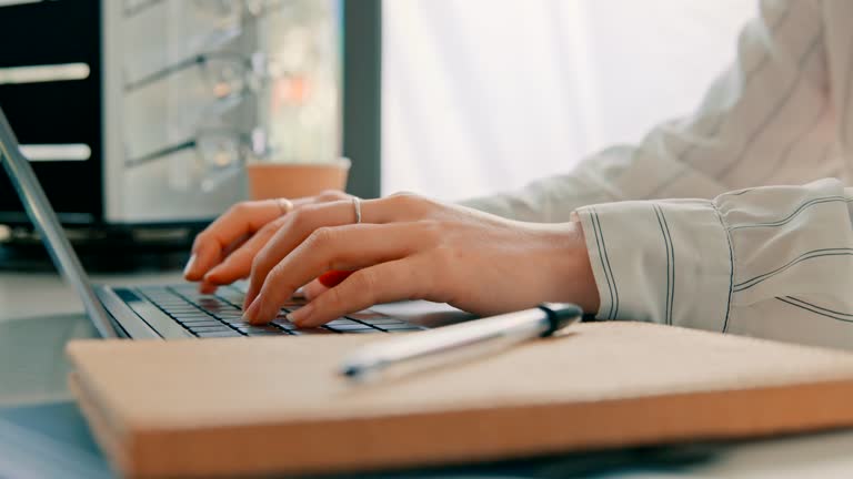 Hands, closeup and typing on a work laptop for business, website or search on the internet. Research, office and a person with a computer for email, connection or corporate communication at a desk